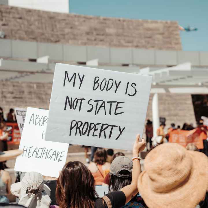 protest sign that says "my body is not state property"