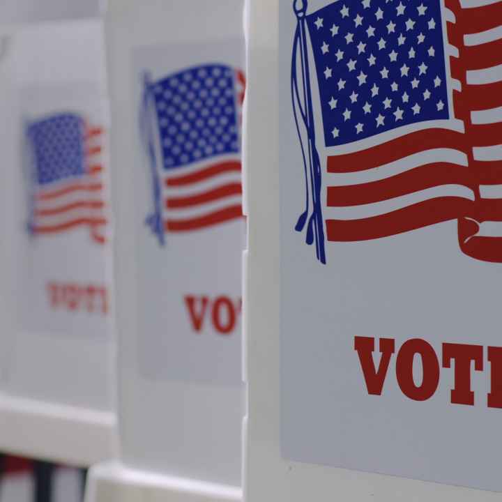 row of 4 voter boxes. On the front is the American flag and underneath in red it reads "vote."