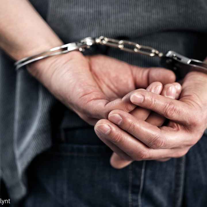 Man with hands handcuffed behind his back