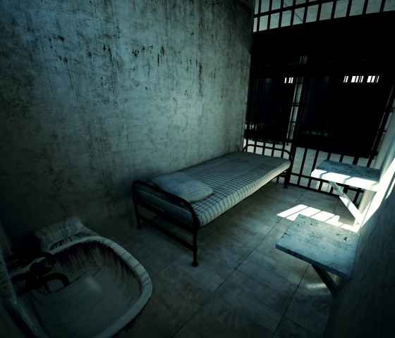 Dark prison cell with a bed and toilet