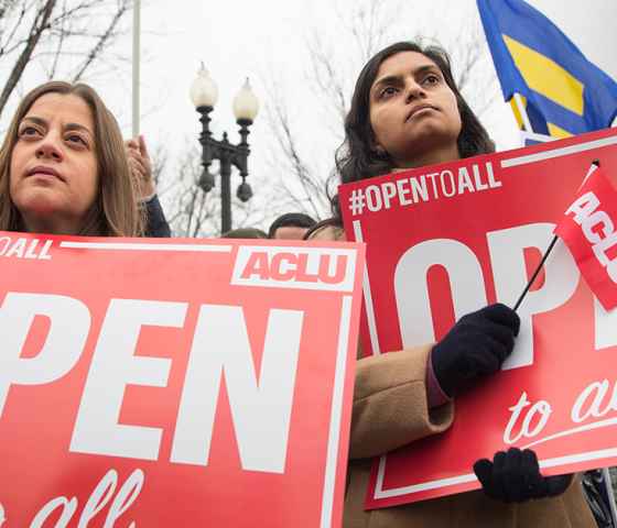 Demonstrators holding signs with the message &quot;Open to All&quot;